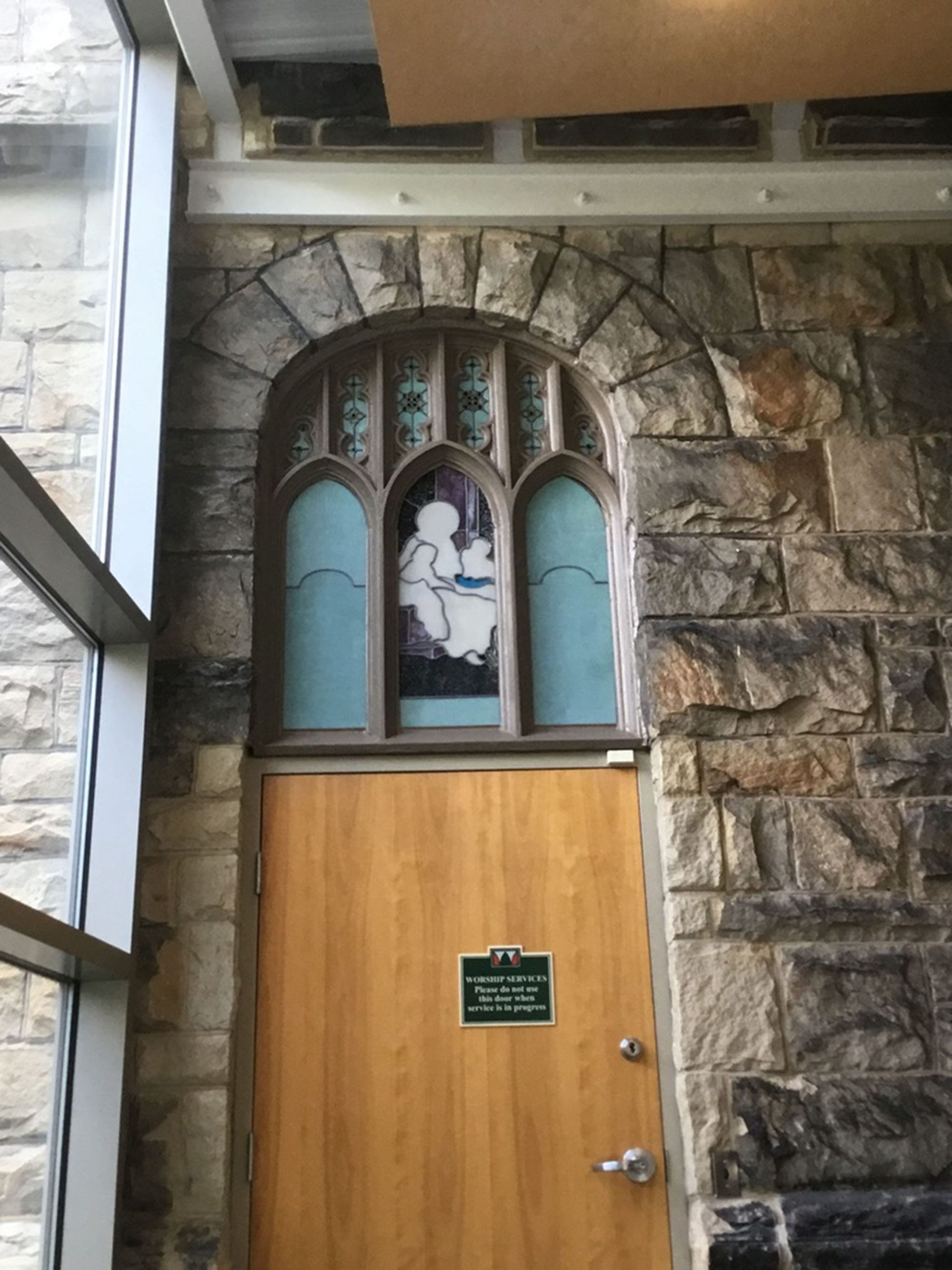 Close-up of stained glass above a door.