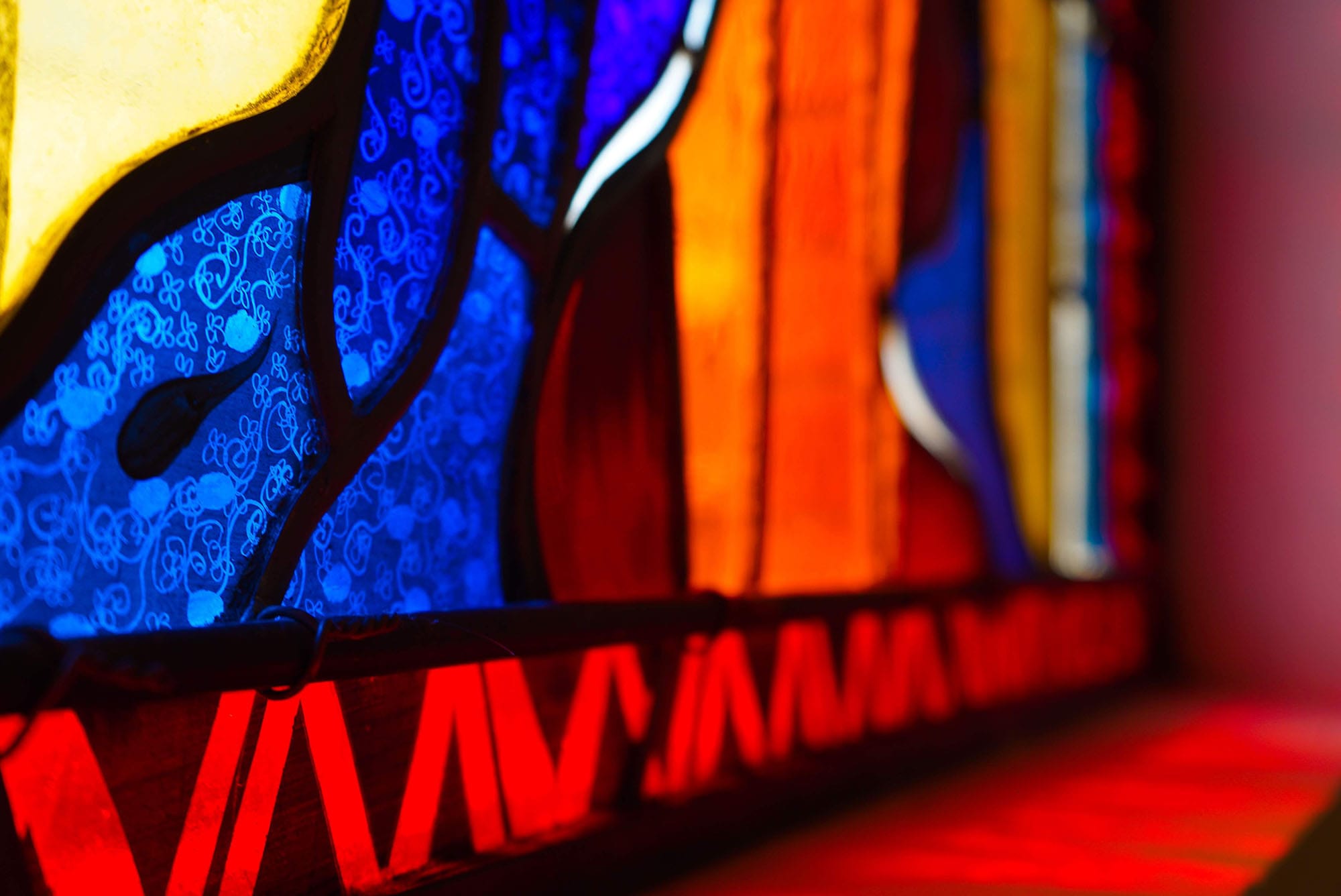 A close-up of the bottom trim of a modern architectural glass window.