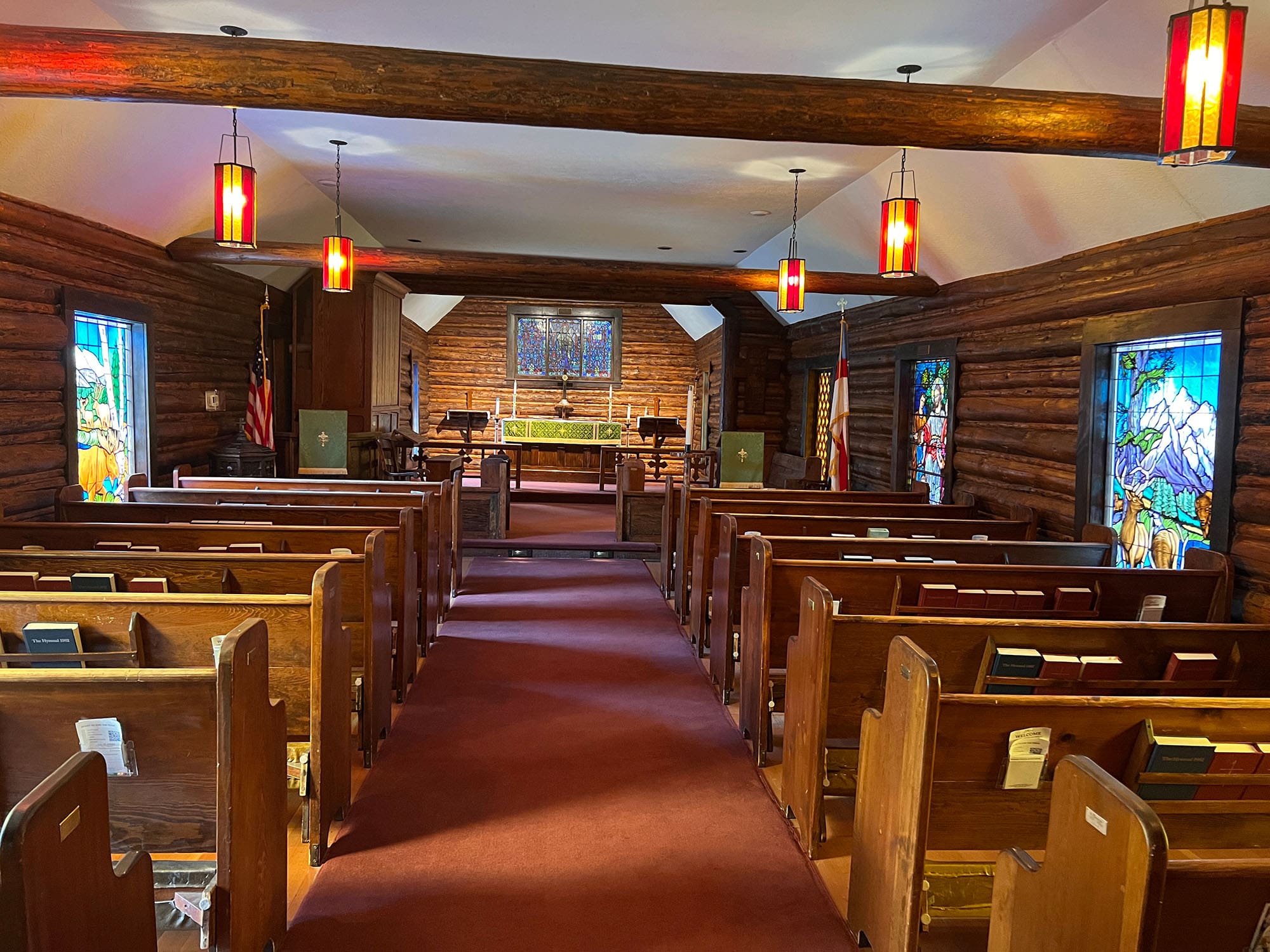 The inside of a church with modern architectural design of North American animals in the woods and mountains.