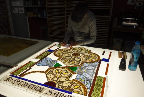 A Willet employee works on stained glass restoration.