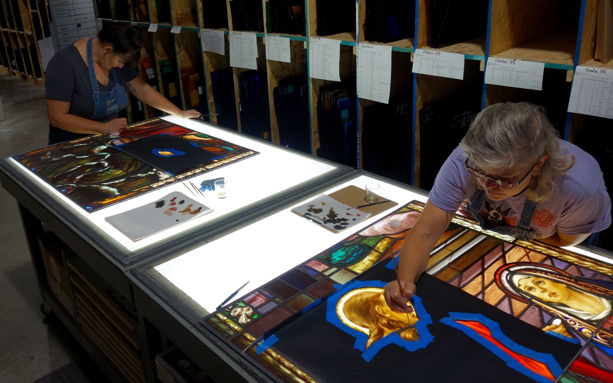 Willet employees work on stained glass restoration.