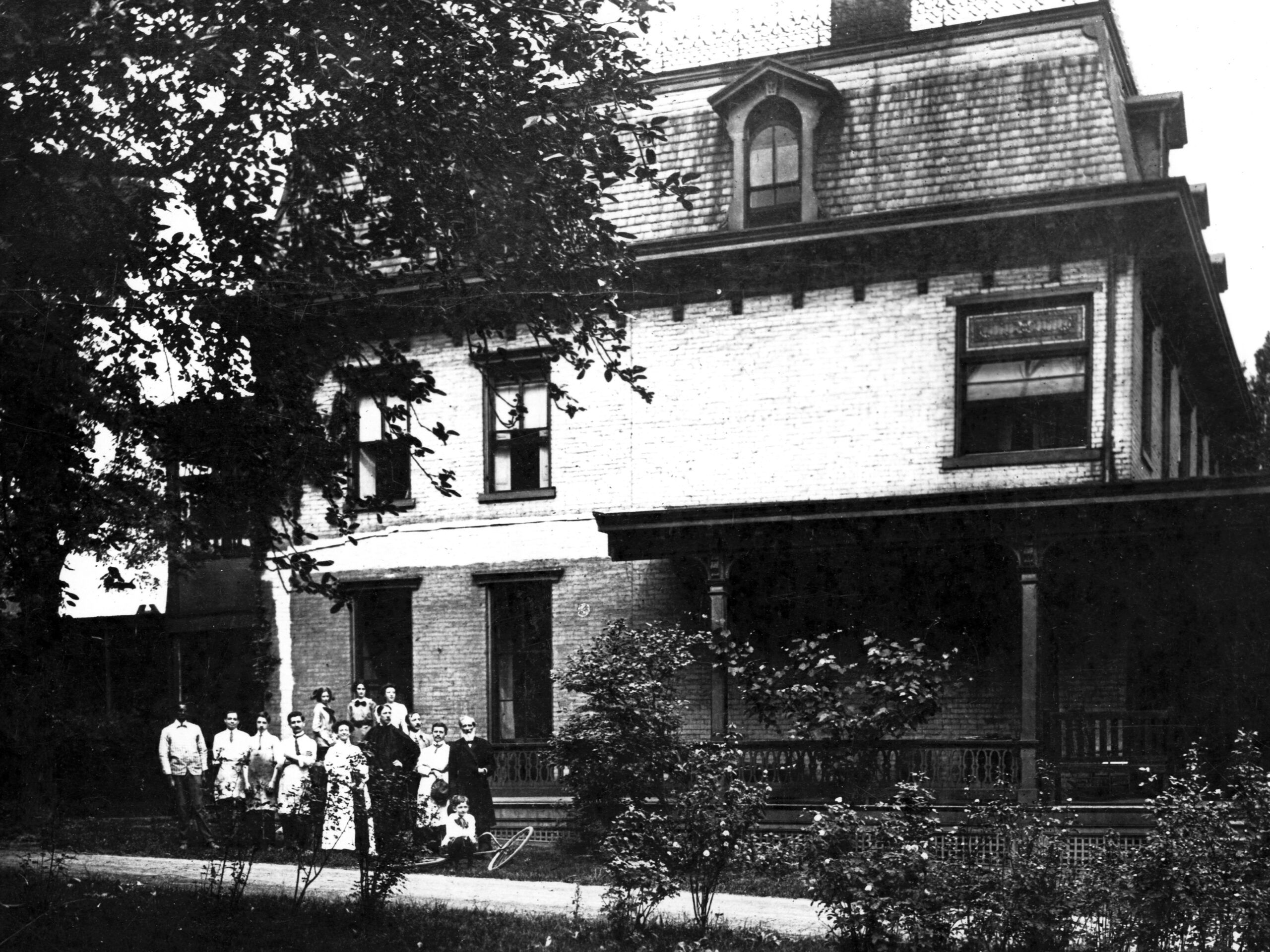Willet family standing in front of historic Pittsburgh studio, showcasing early 20th-century architecture and the legacy of Willet Stained Glass Studios.
