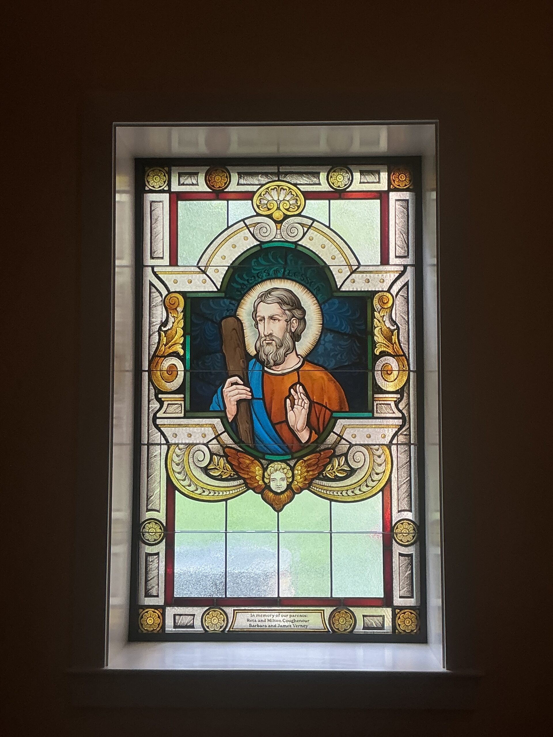 Stained glass window depicting a biblical figure with a staff, surrounded by ornate designs and vibrant colors, representing faith and artistry in worship spaces by Willet Stained Glass Studios.