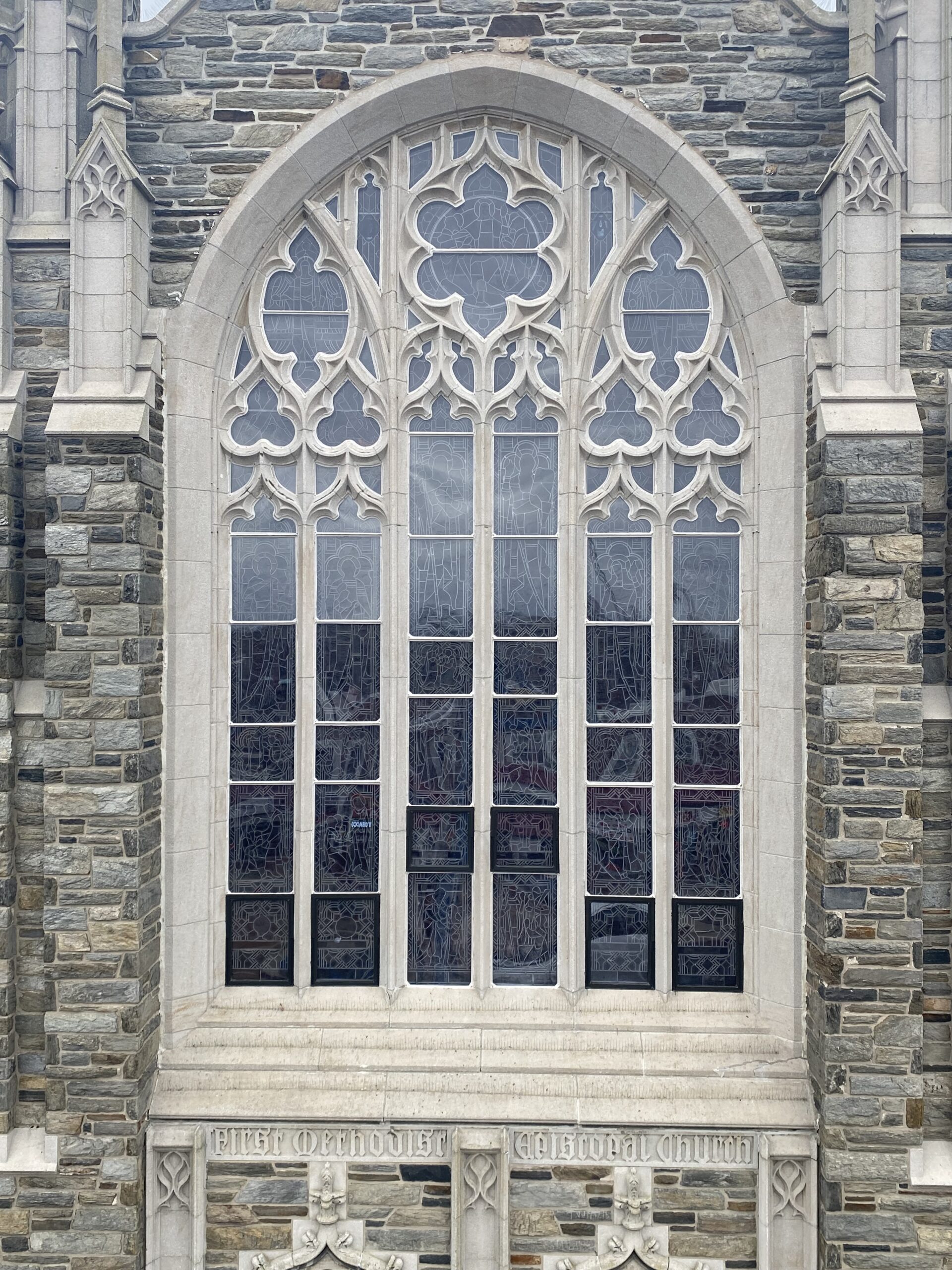 Historic stained glass window with intricate Gothic design, showcasing lead came details and structural features, part of a church restoration project by Willet Studios.