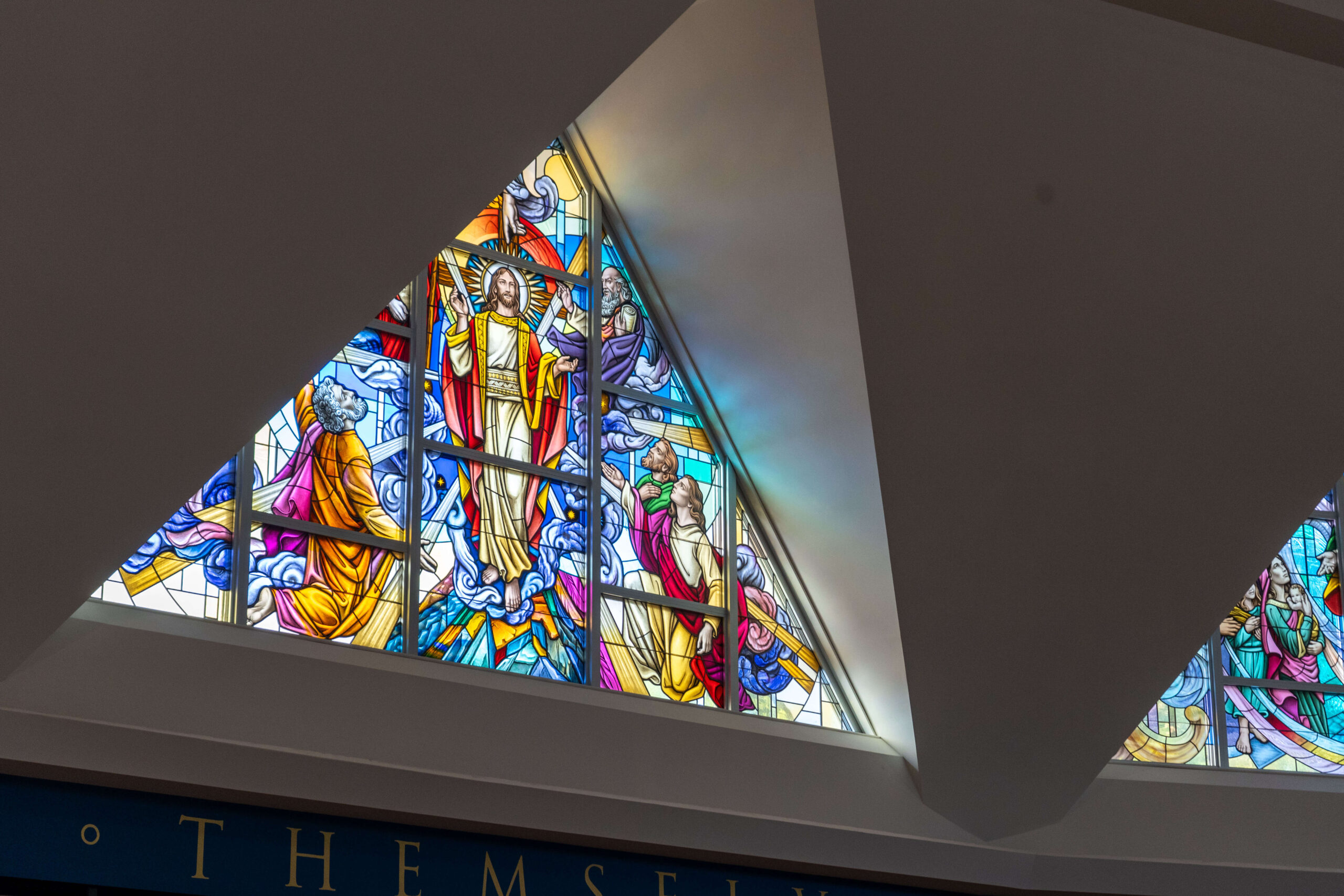 Stained glass window depicting Jesus and biblical figures, showcasing vibrant colors and intricate designs, enhancing a sacred worship space, aligned with Willet Stained Glass Studios' mission of creating meaningful religious art.