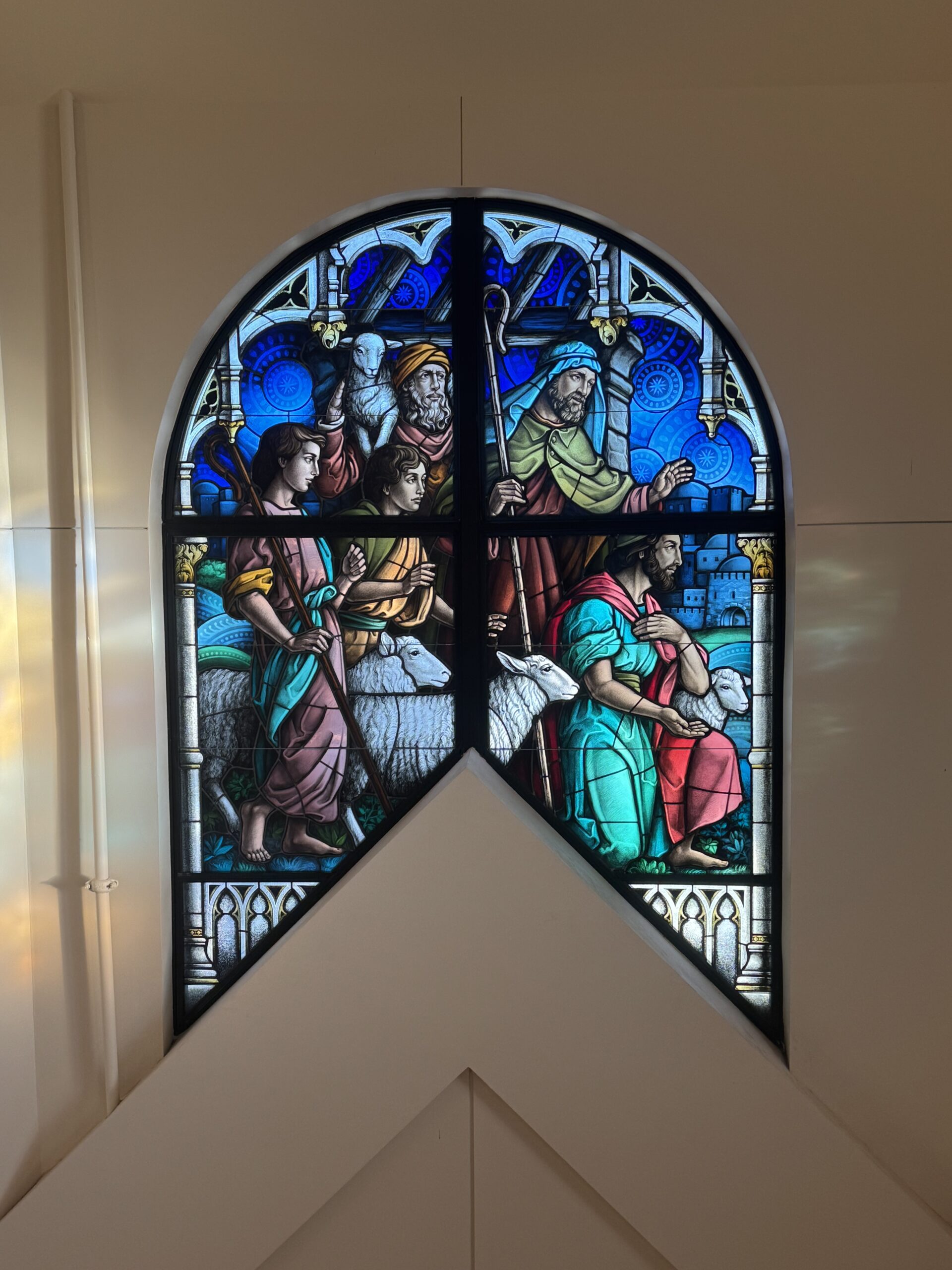 Stained glass window depicting biblical figures in vibrant colors, showcasing faith and community, enhancing worship spaces for congregations.