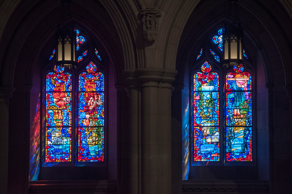 Stained glass windows depicting scenes from the Lewis and Clark expedition, featuring vibrant colors and intricate designs, located in a historic church setting, showcasing Willet Stained Glass Studios' artistry and craftsmanship.