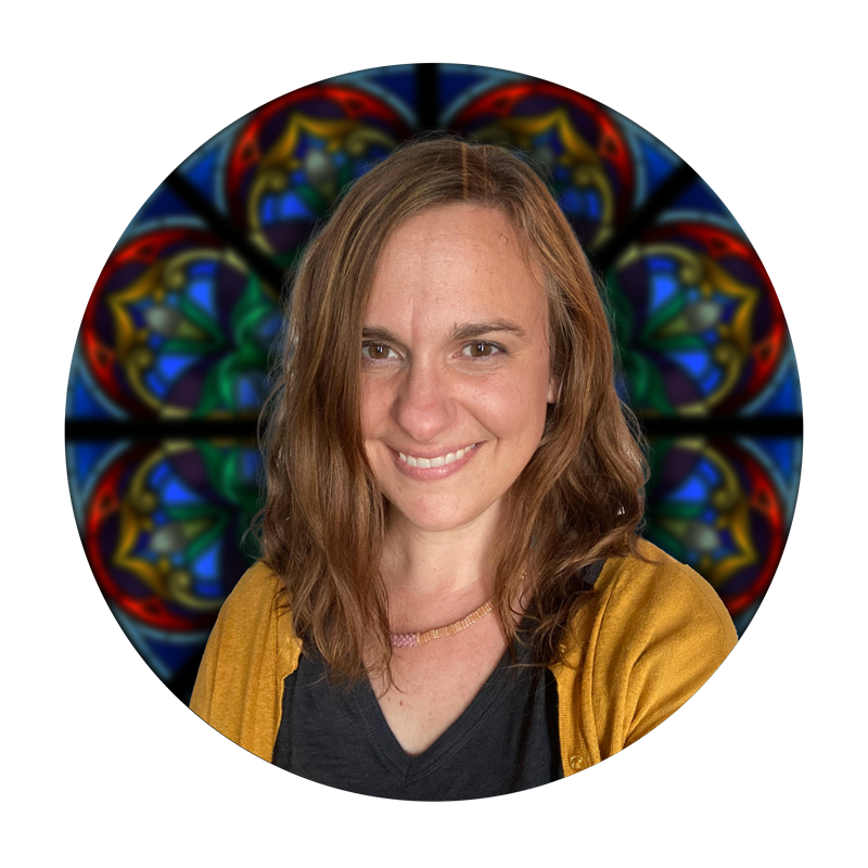 Audrey Walker, Studio Manager at Willet Stained Glass Studios, smiling in front of a colorful stained glass background.