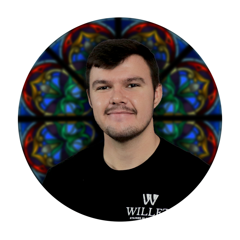 Benny McMartin, Senior Production Specialist at Willet Stained Glass Studios, with stained glass design background.