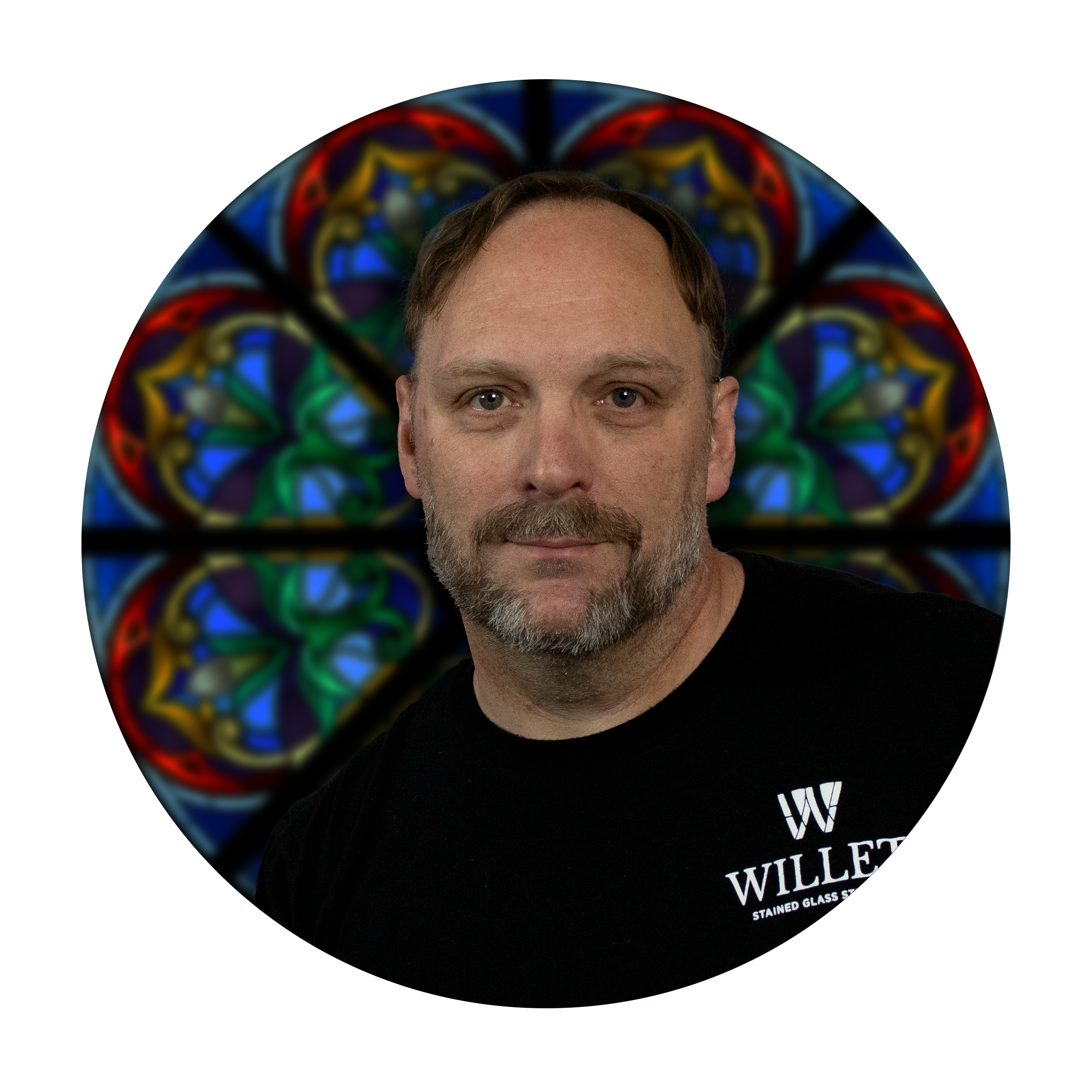 Judson Portzer, glass painter and designer at Willet Stained Glass Studios, with stained glass background.