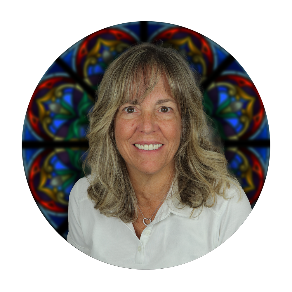 Kathy Jordan, Director of Art Development at Willet Stained Glass Studios, smiling in front of a stained glass window design background.