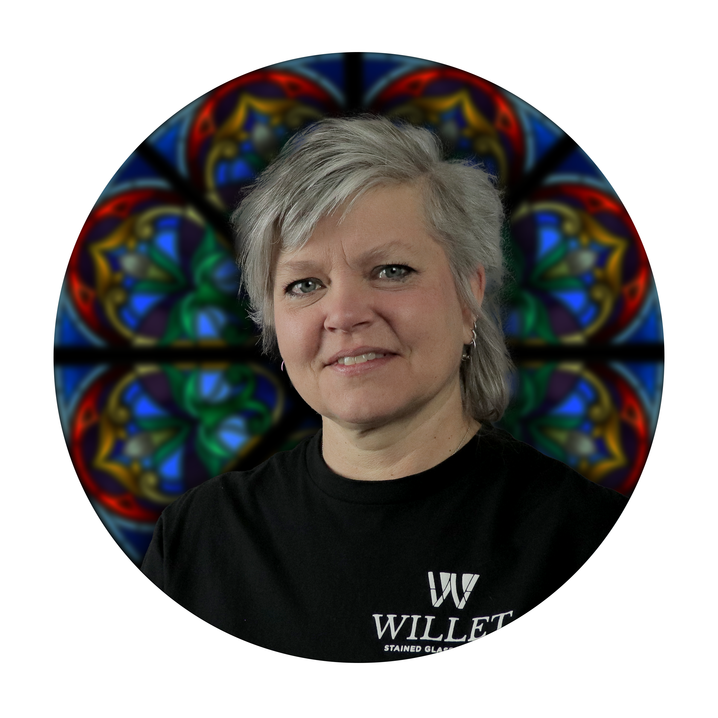 Melissa Janda, Director of Art Production at Willet Stained Glass Studios, with a colorful stained glass backdrop.
