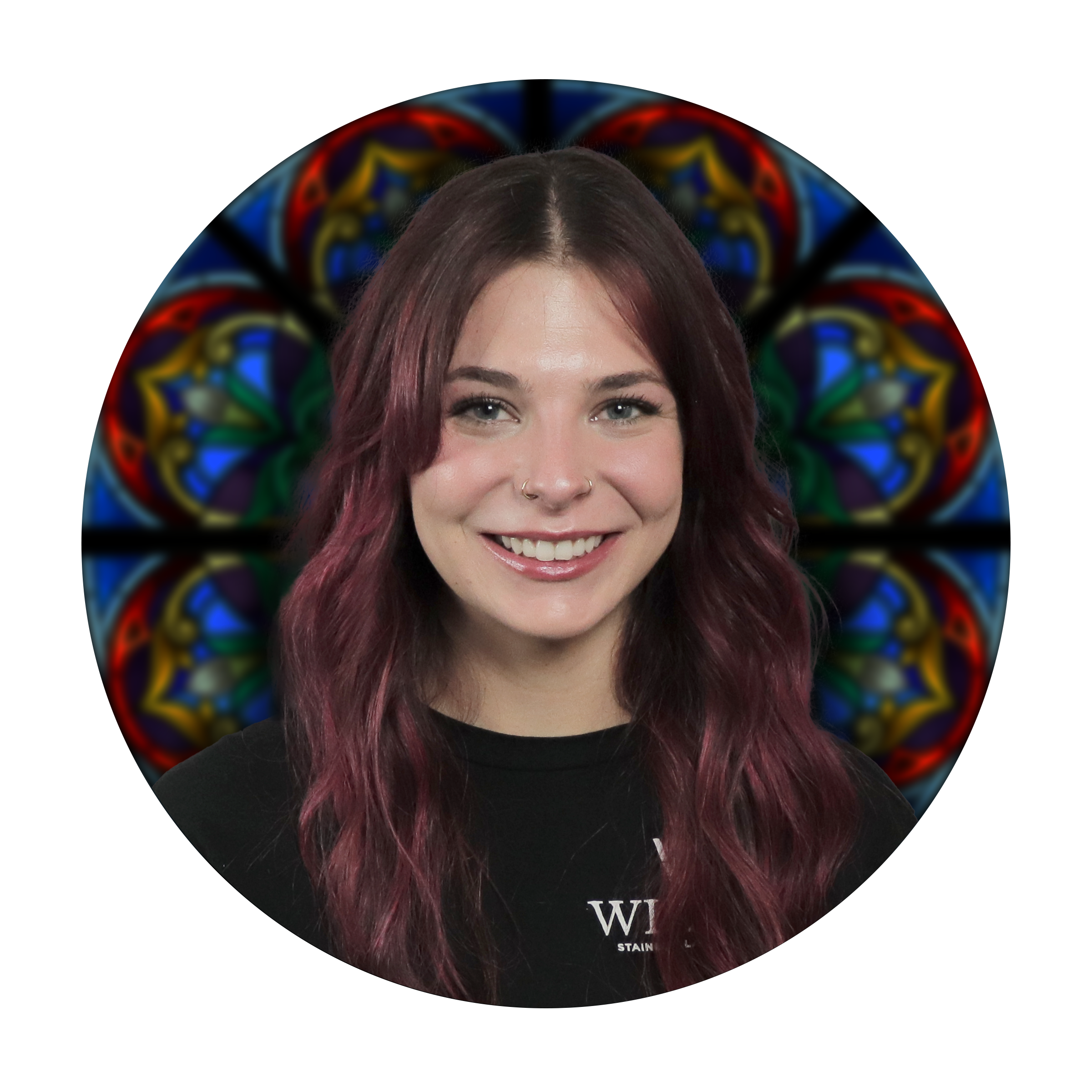 Morgan Ness, Glass Painting Specialist at Willet Stained Glass Studios, smiling in front of a colorful stained glass background.