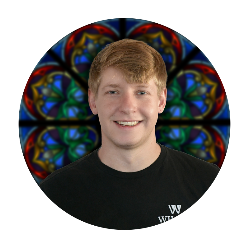 Scott Graninger, Production Specialist at Willet Stained Glass Studios, with colorful stained glass background.