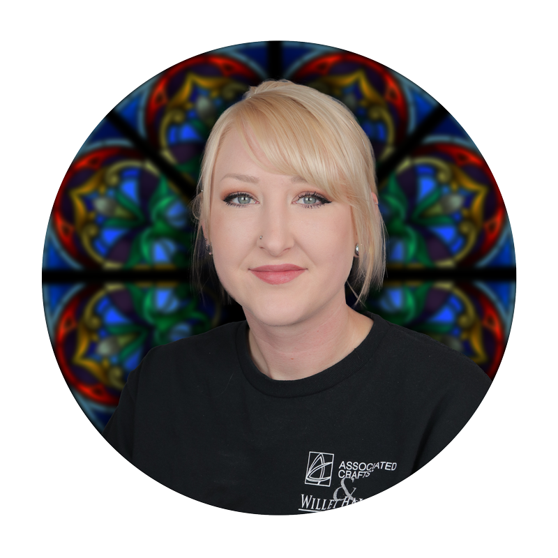 Jen Grosheck, Glazing Specialist at Willet Stained Glass Studios, with stained glass background.