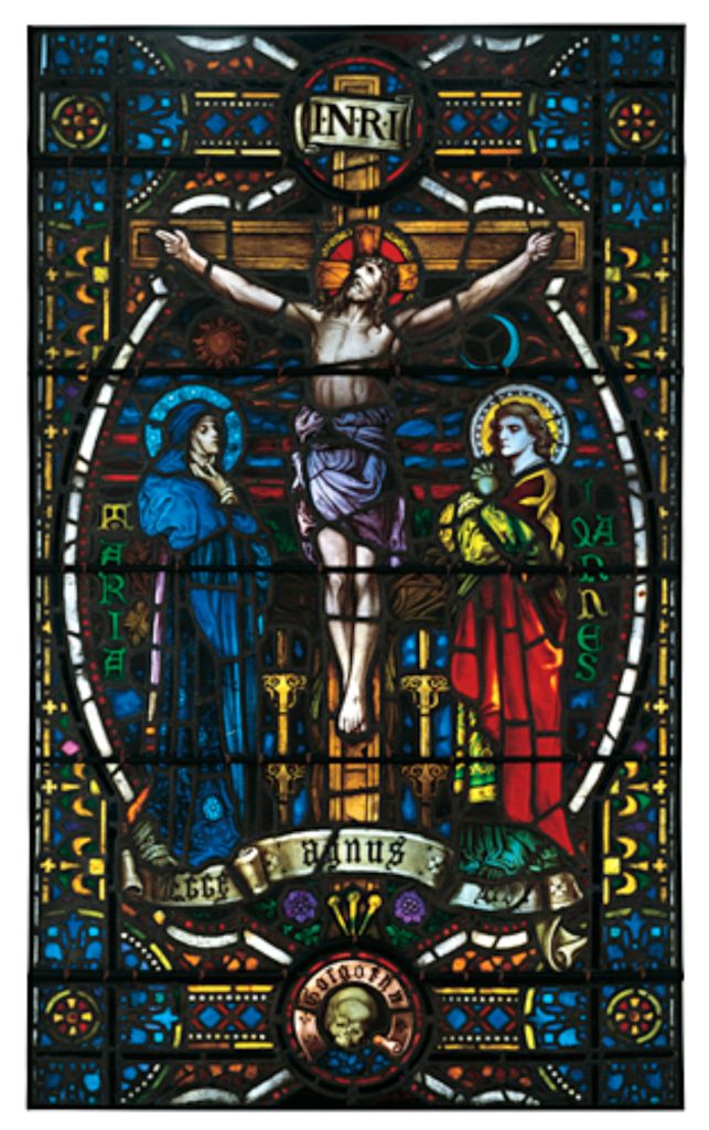 Stained glass window depicting the crucifixion of Jesus, flanked by Mary and John, featuring intricate colors and details, representing artistry and historical significance in stained glass craftsmanship.
