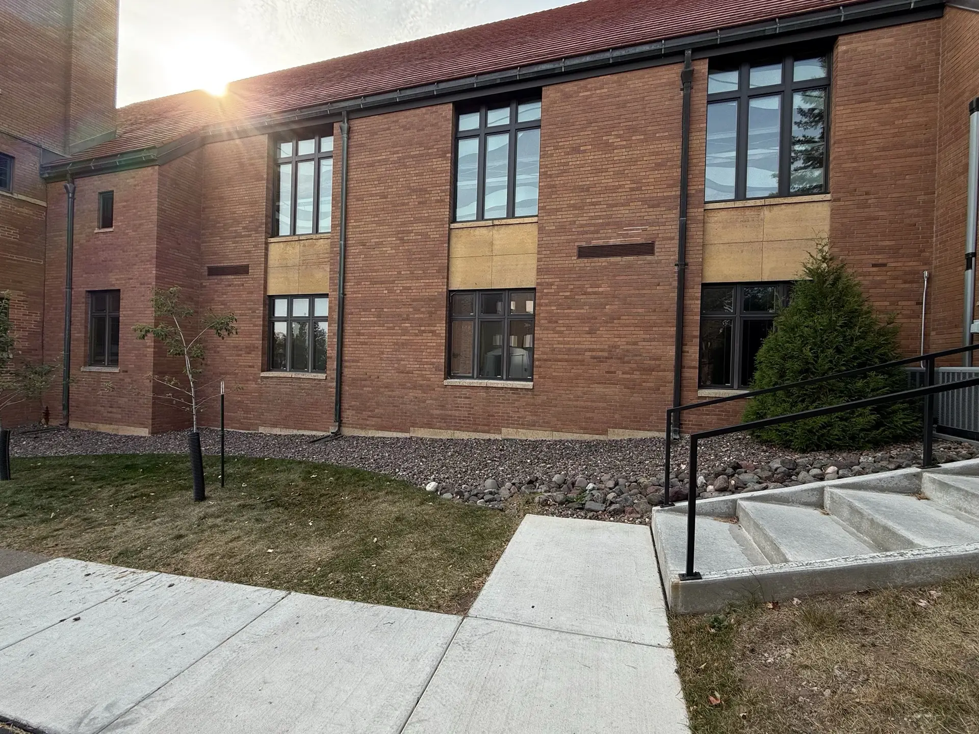 Historic building exterior with protective glazing and window coverings.
